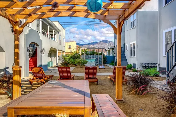 a view of a patio with couches chairs and potted plants