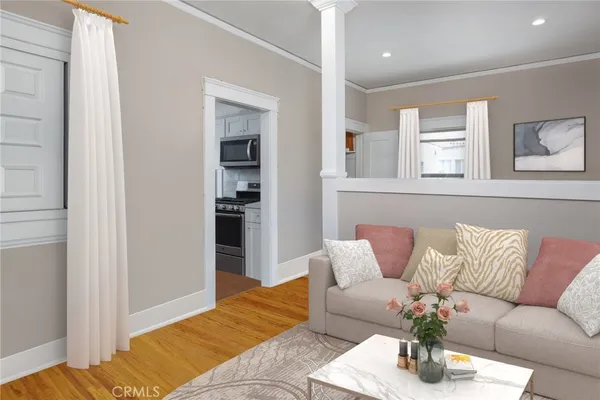 a living room with furniture and wooden floor