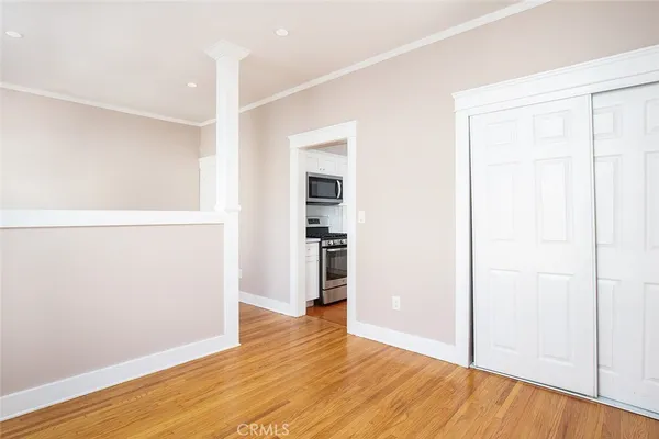 a view of empty room with wooden floor