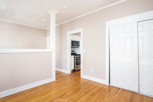 a view of empty room with wooden floor