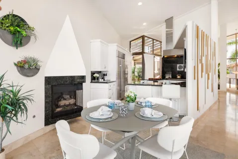 a kitchen with granite countertop a sink dishwasher stove and white cabinets