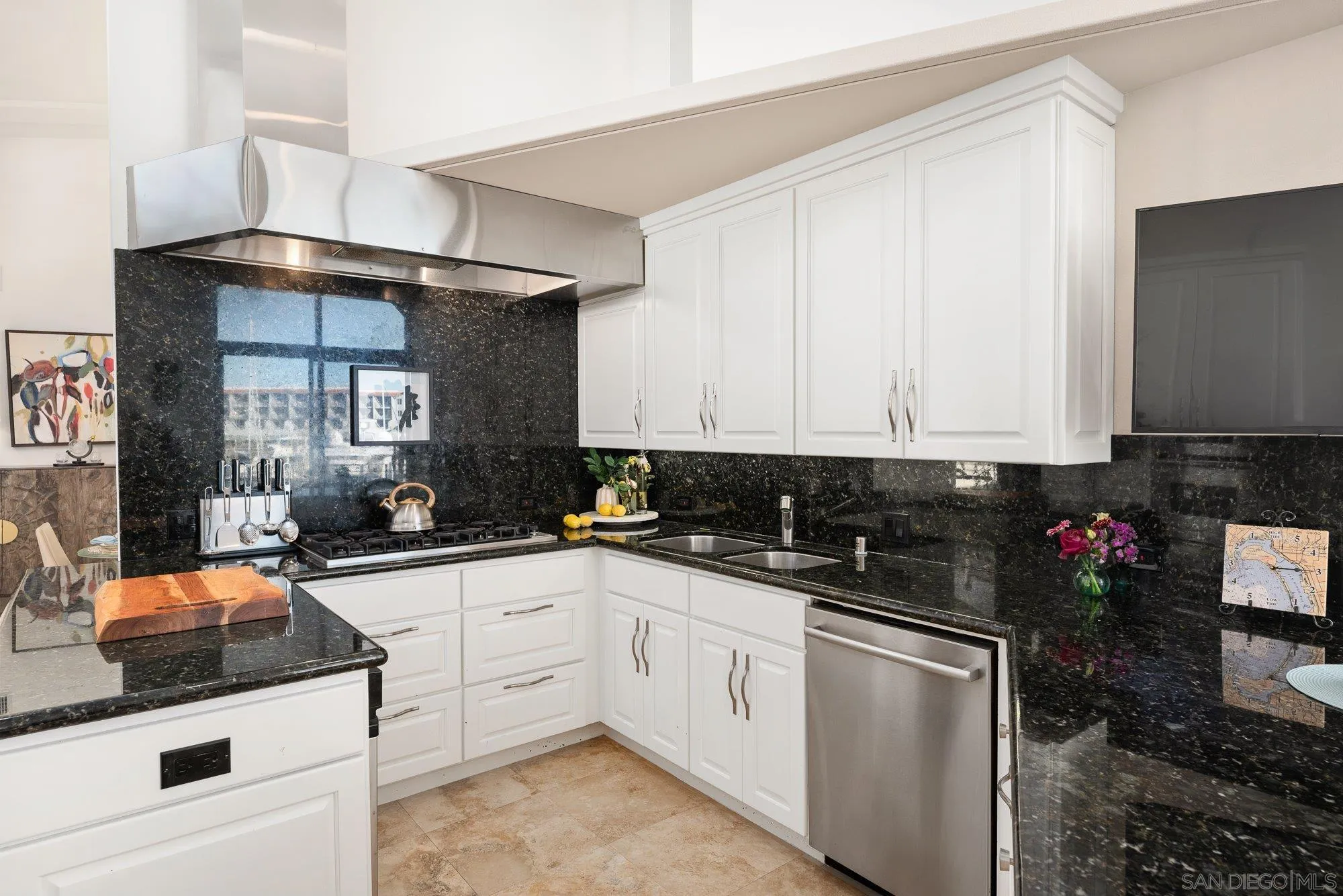25 The Point Coronado, CA 92118 - Photo 23 of 74 a kitchen with granite countertop a sink dishwasher stove and white cabinets