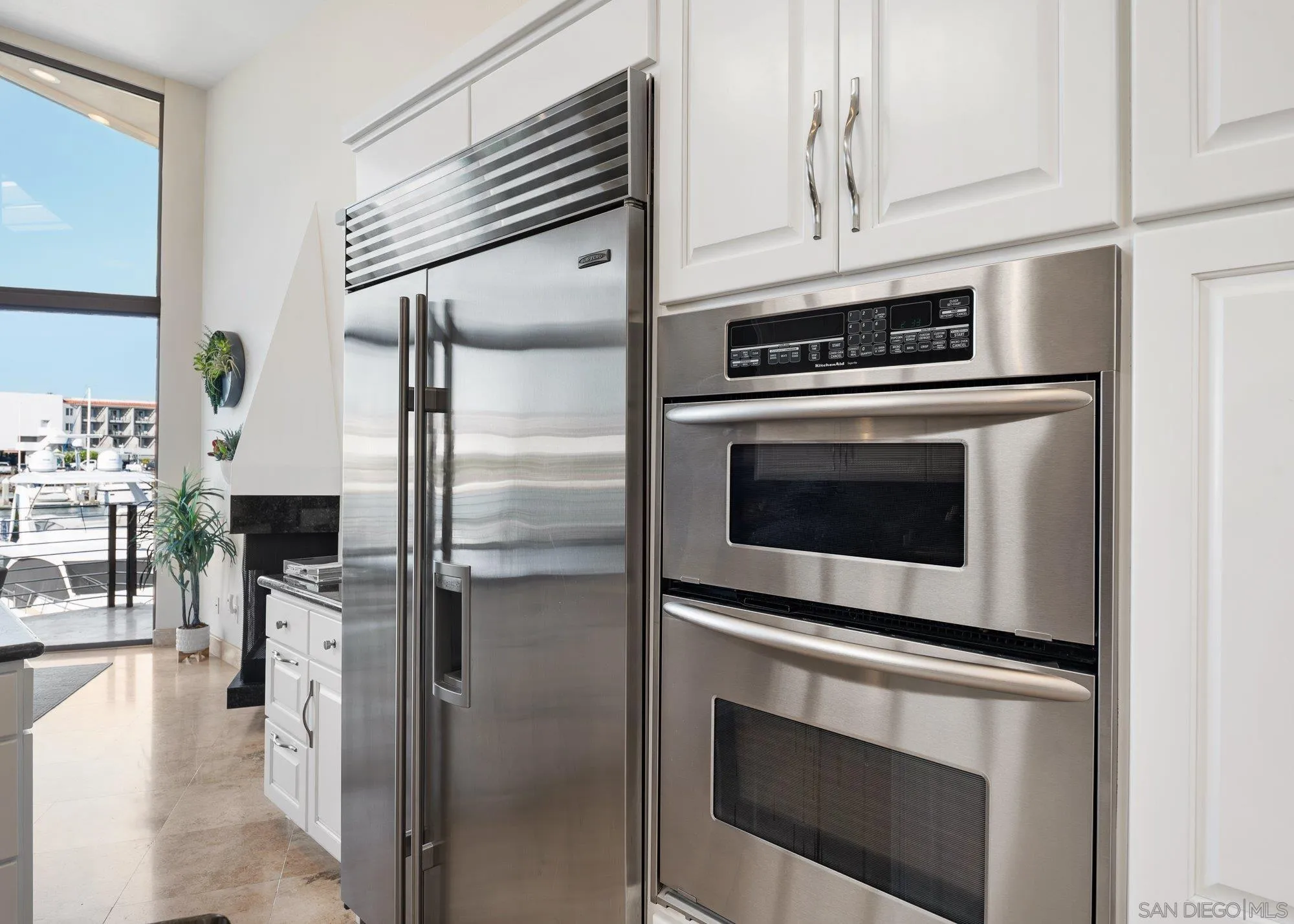 25 The Point Coronado, CA 92118 - Photo 25 of 74 a kitchen with stainless steel appliances white cabinets and a counter top space