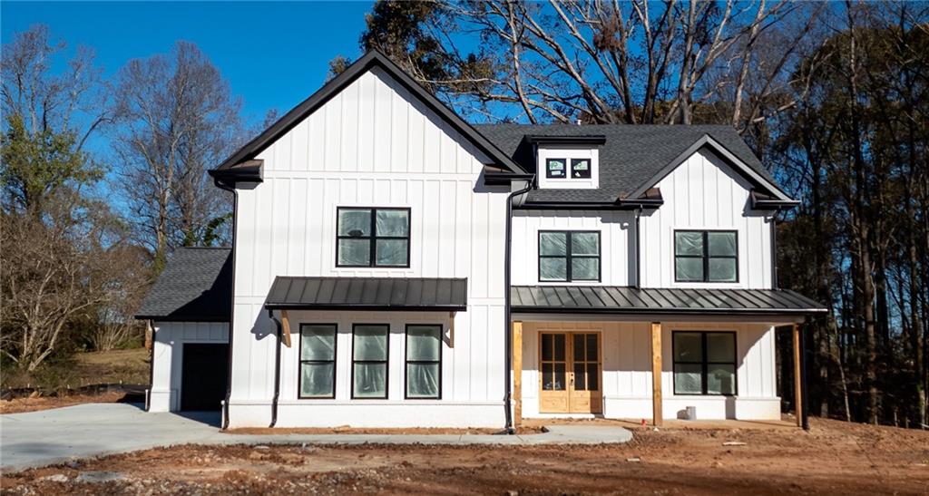 1002 Auburn Road Dacula, GA 30019 - Photo 1 of 1 a view of a white house with a large window and large tree