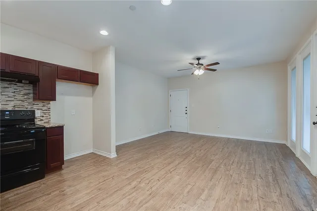 a view of a kitchen with a sink cabinets and wooden floor