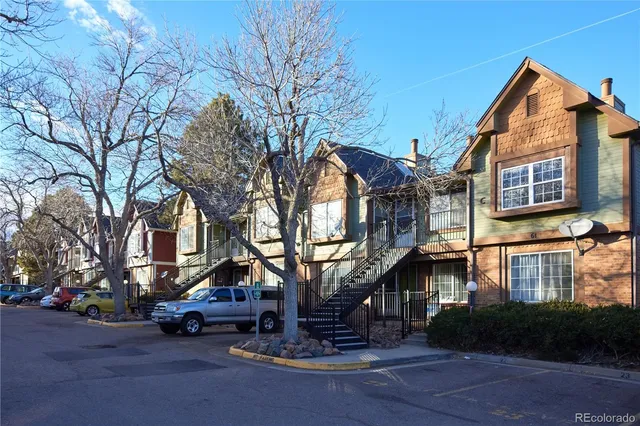 a front view of a house with a tree