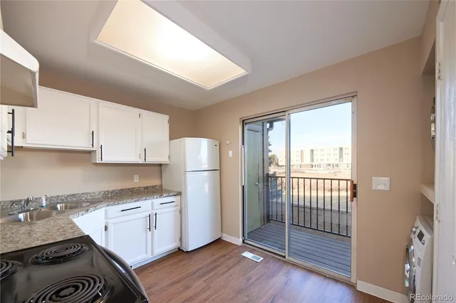 a kitchen with a refrigerator a sink and cabinets
