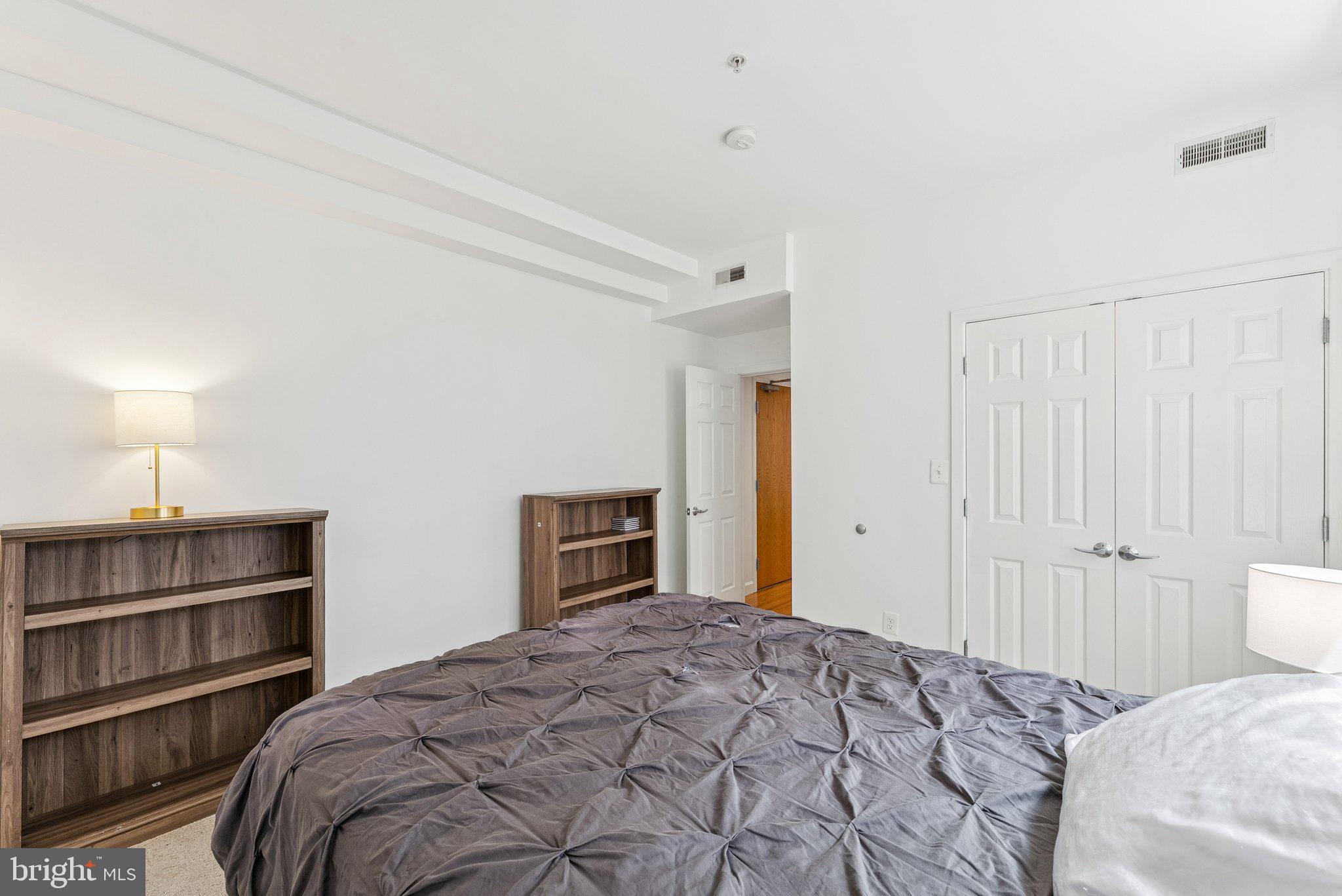 1440 Columbia Road Northwest, Unit 204 Washington, DC 20009 - Photo 12 of 23 a bedroom with a bed and a closet