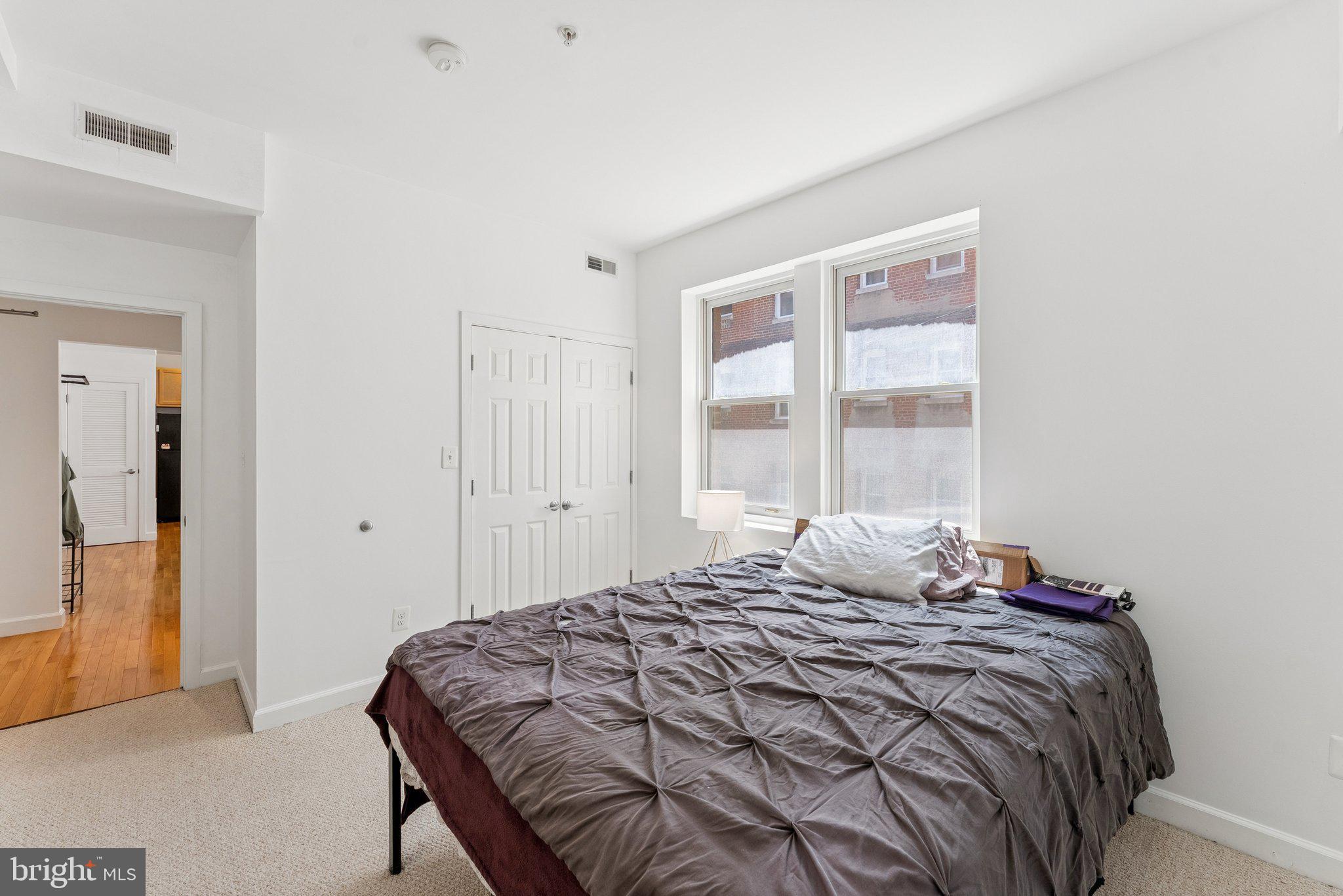1440 Columbia Road Northwest, Unit 204 Washington, DC 20009 - Photo 13 of 23 a bedroom with a bed and a window