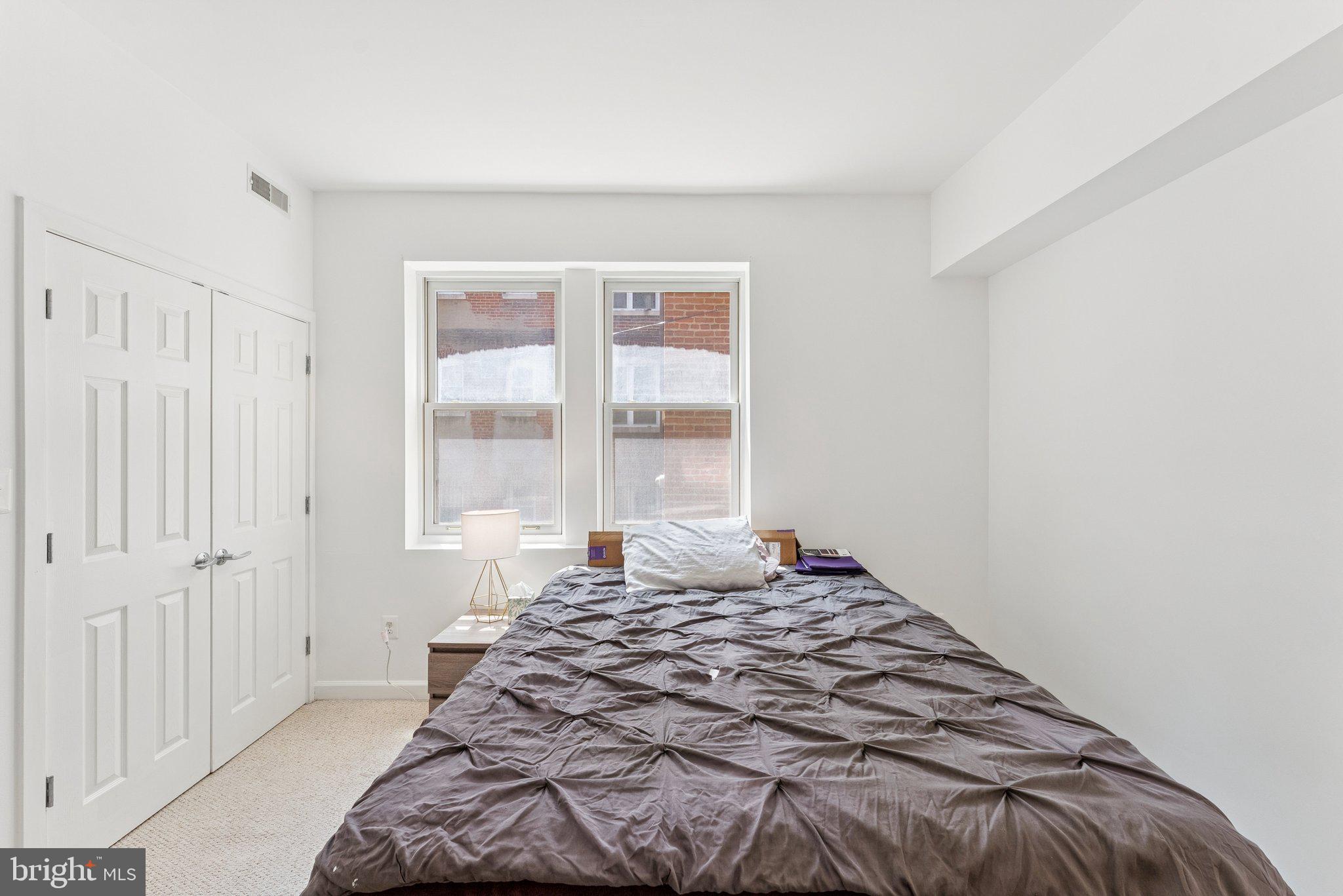 1440 Columbia Road Northwest, Unit 204 Washington, DC 20009 - Photo 14 of 23 a bedroom with a bed and a window