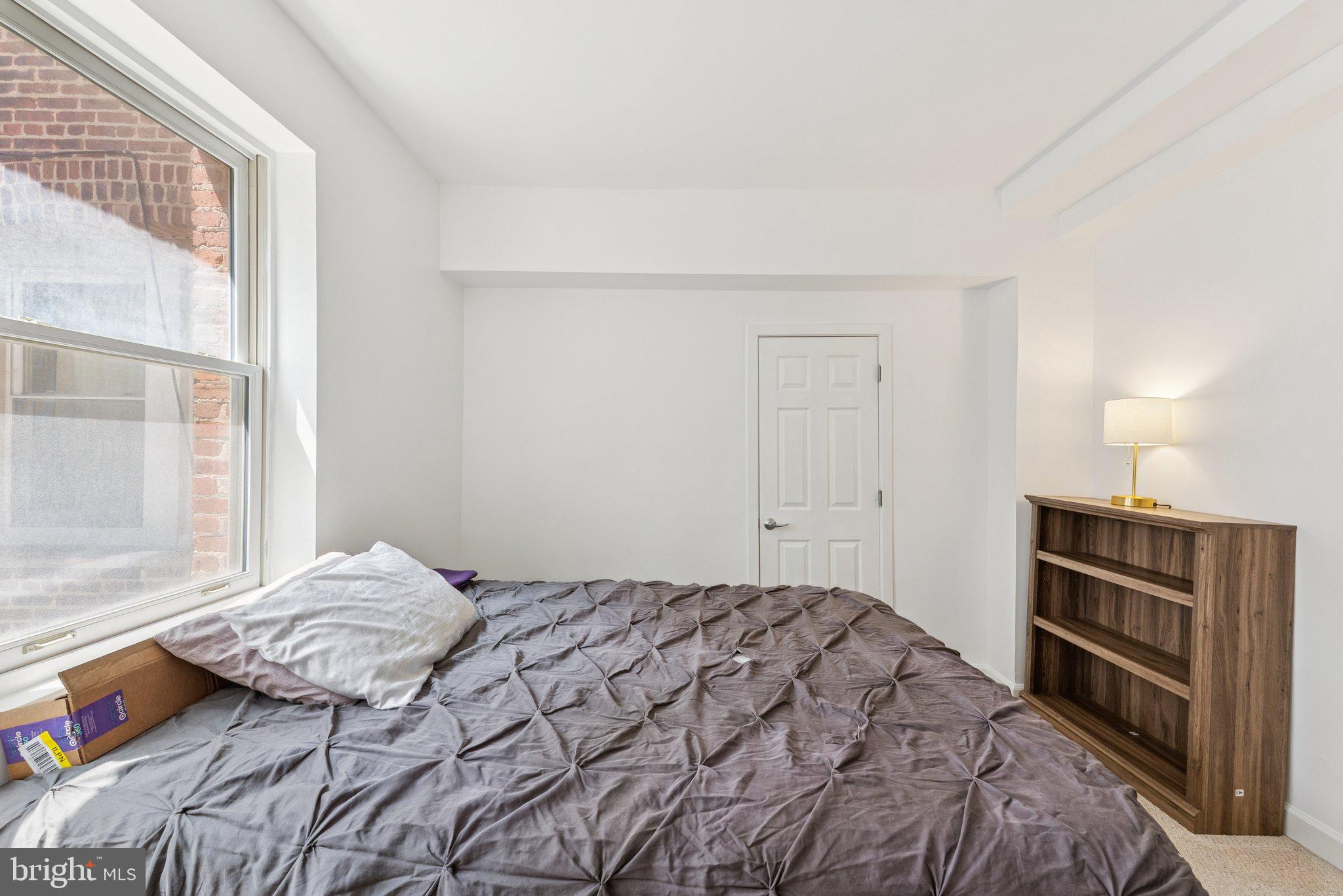 1440 Columbia Road Northwest, Unit 204 Washington, DC 20009 - Photo 15 of 23 a bedroom with a bed and a window