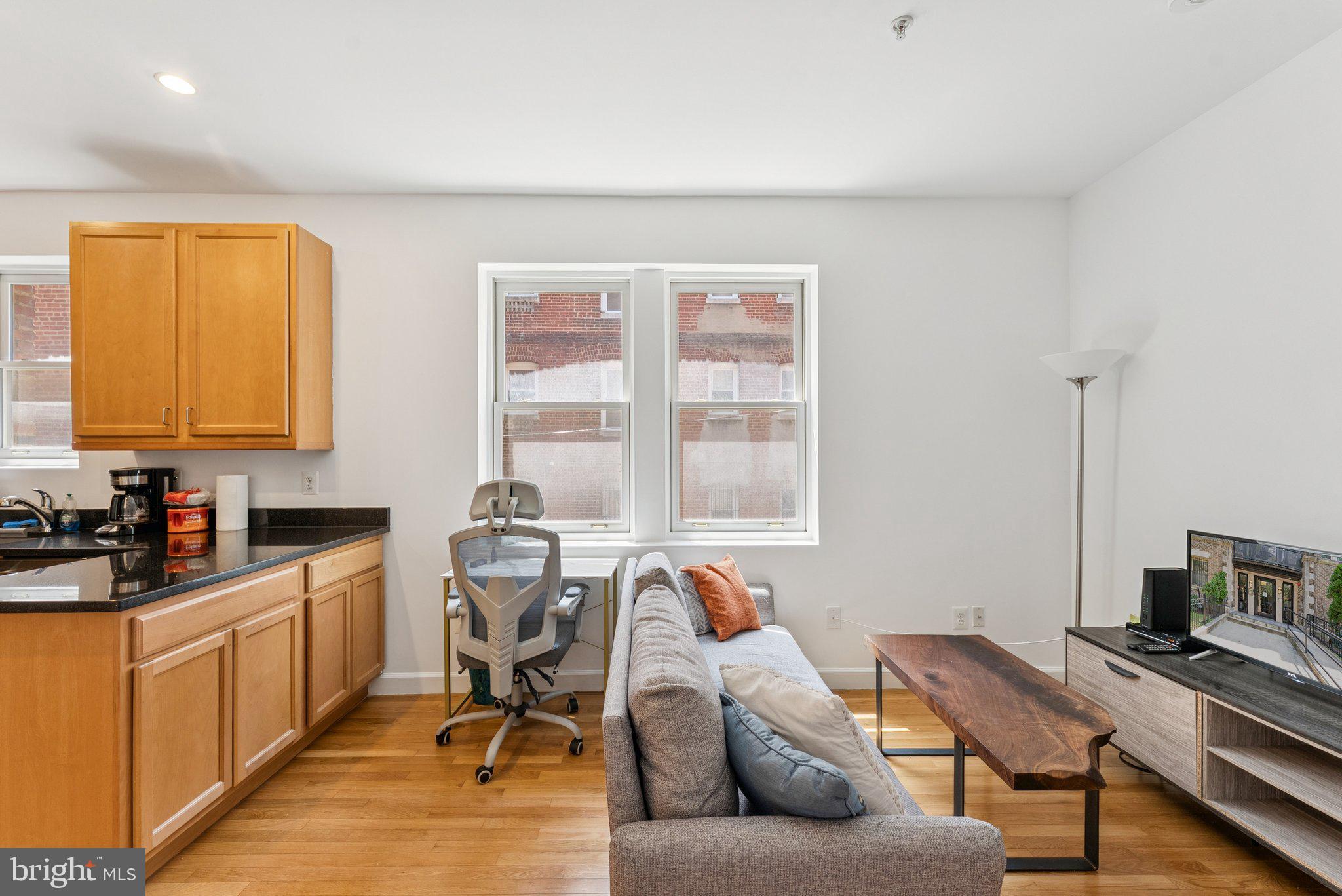1440 Columbia Road Northwest, Unit 204 Washington, DC 20009 - Photo 4 of 23 a living room with furniture and a window