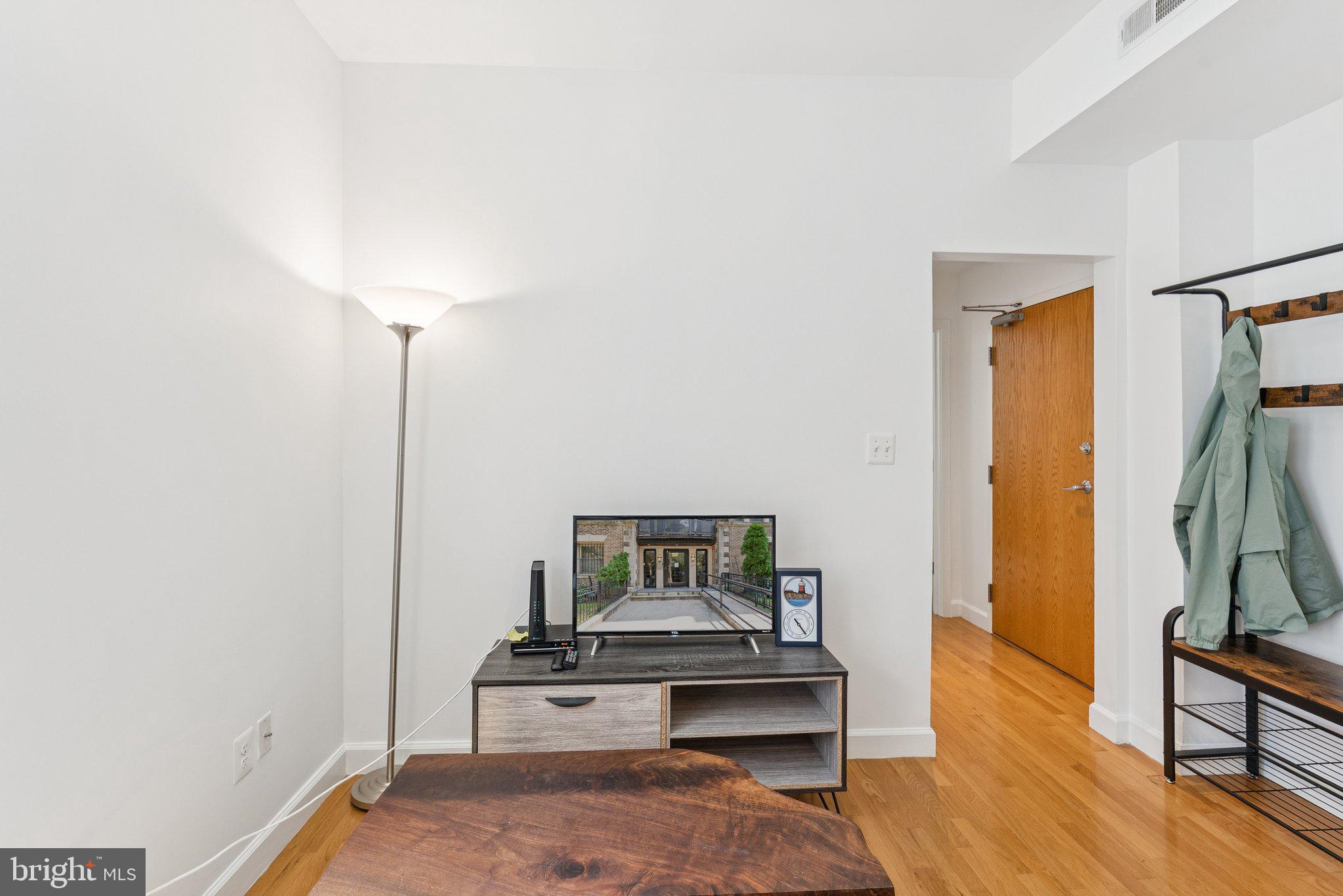 1440 Columbia Road Northwest, Unit 204 Washington, DC 20009 - Photo 9 of 23 a living room with furniture and a wooden floor
