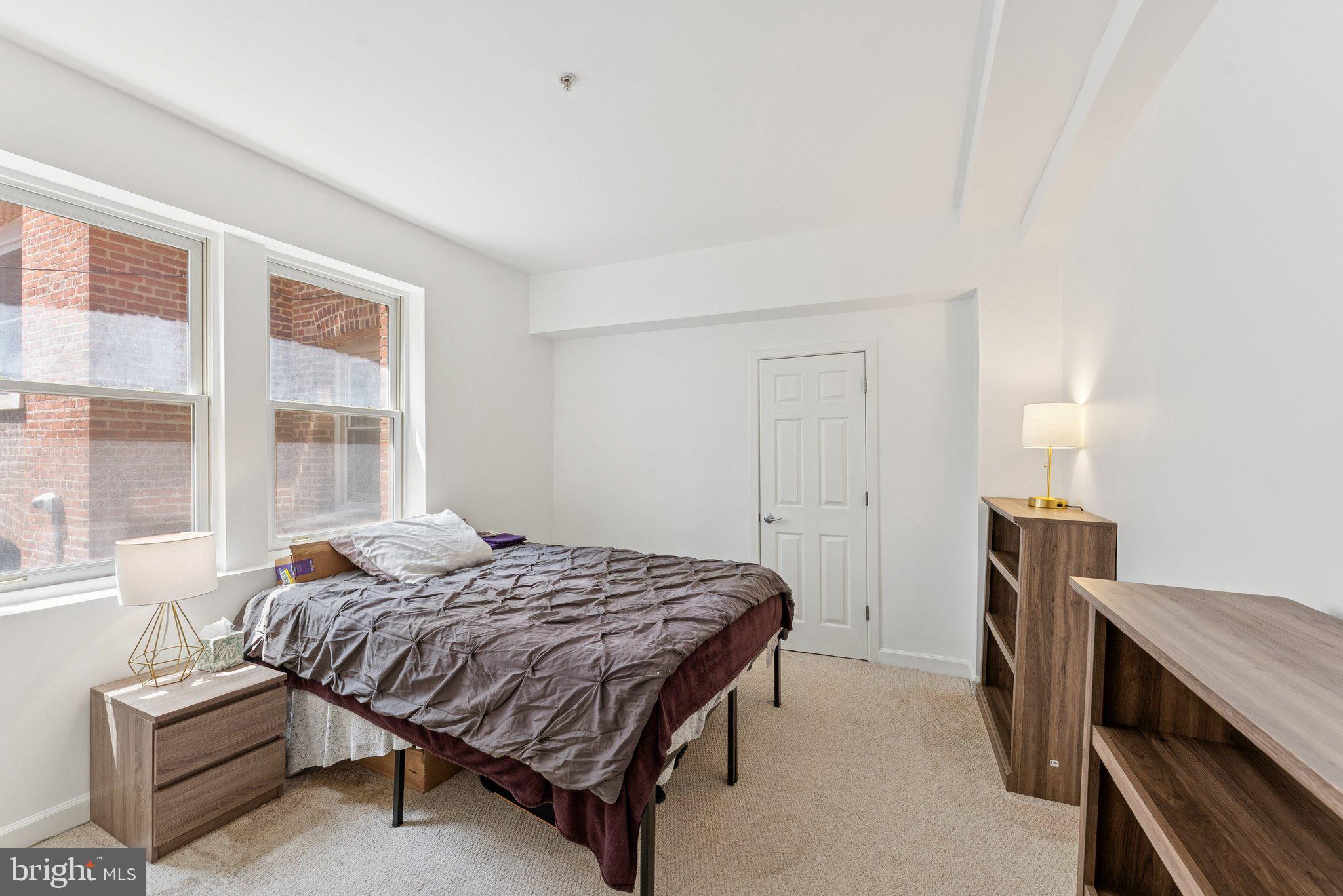 1440 Columbia Road Northwest, Unit 204 Washington, DC 20009 - Photo 10 of 23 a bedroom with a bed and a dresser next to a window