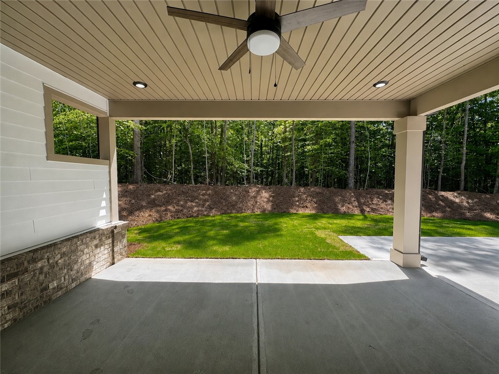 328 Point Road Westminster, SC 29693 - Photo 22 of 24 Enjoy forested views from this generous covered patio, complete with a ceiling fan.
