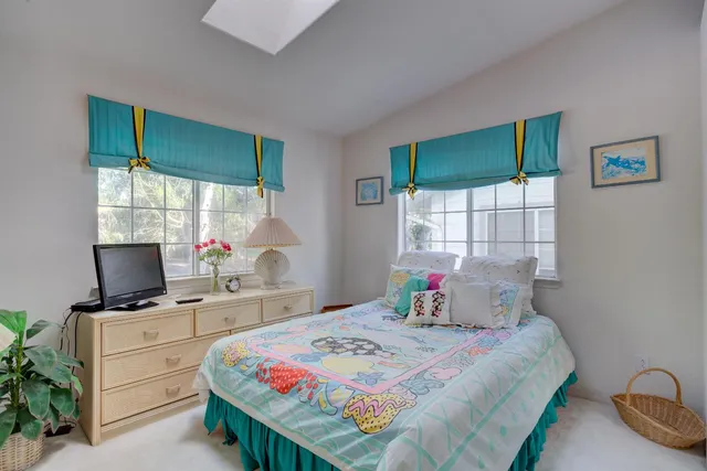 a bedroom with a bed and large window