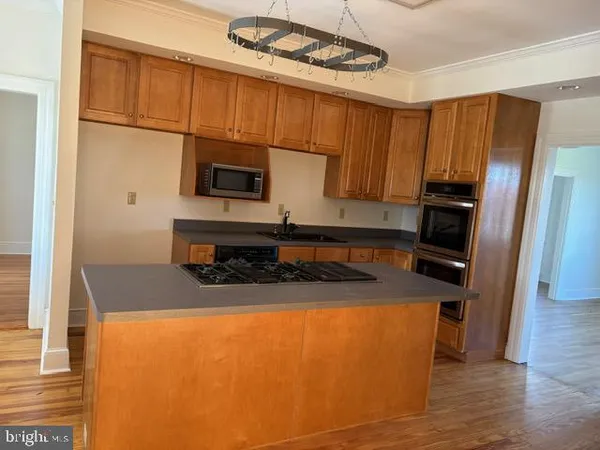 a kitchen with stainless steel appliances granite countertop a refrigerator a stove top oven a sink and dishwasher