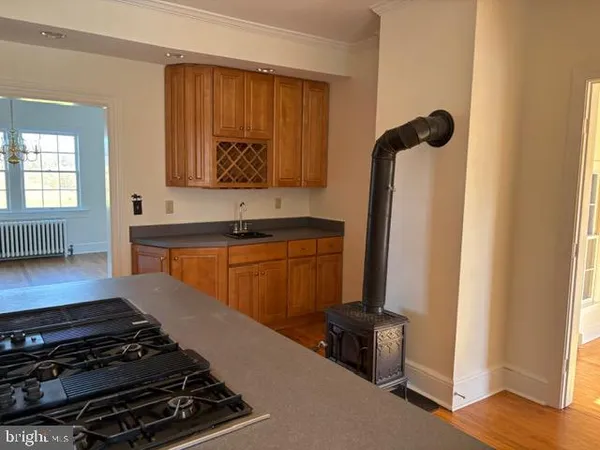 a kitchen with wooden cabinets and a stove top oven