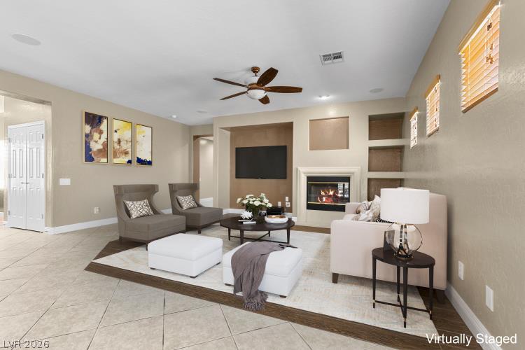 2627 Dirleton Place Henderson, NV 89044 - Photo 11 of 42 Virtually staged Living Room- enjoy this warm hearth in this generously sized living room, featuring a cozy fireplace.