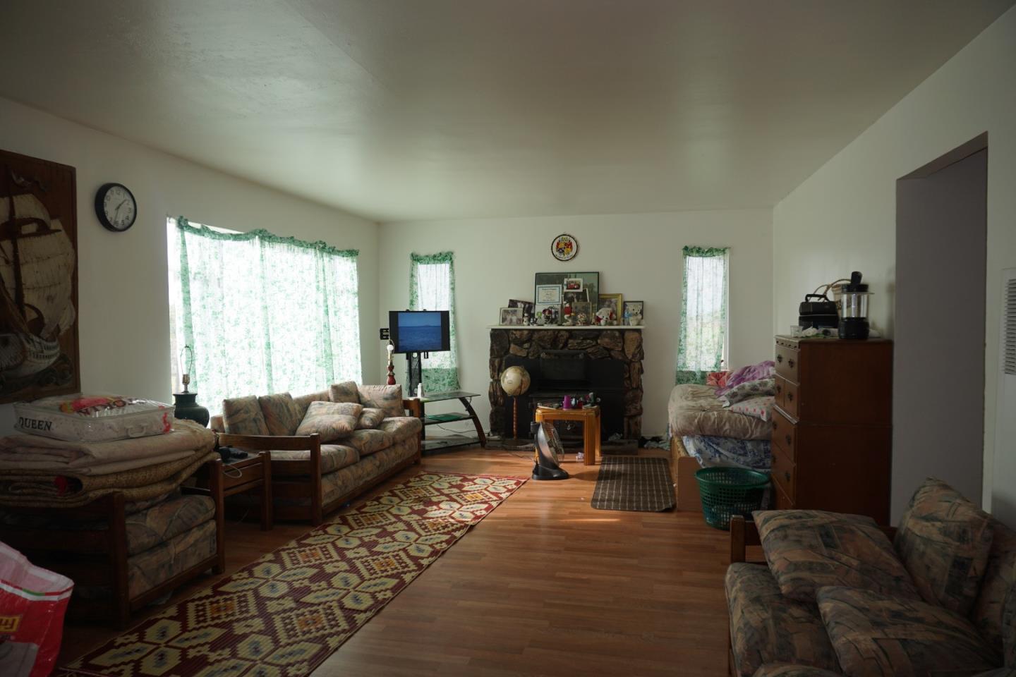 2310 Mt Pleasant Road San Jose, CA 95148 - Photo 2 of 12 a living room with furniture a fireplace and a large window