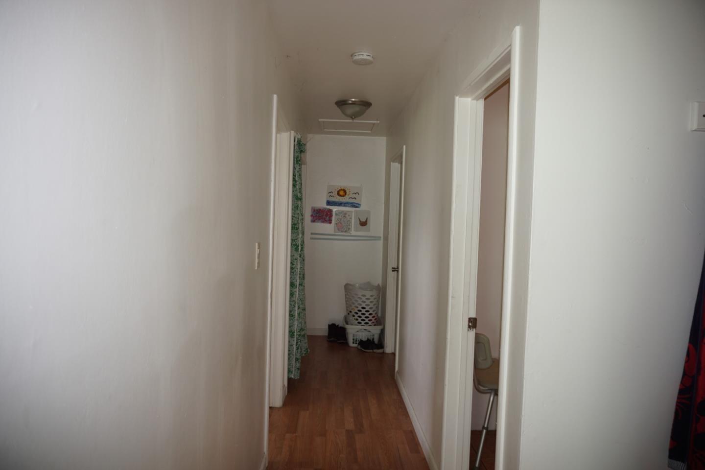 2310 Mt Pleasant Road San Jose, CA 95148 - Photo 3 of 12 a view of a hallway with a livingroom and a bathroom