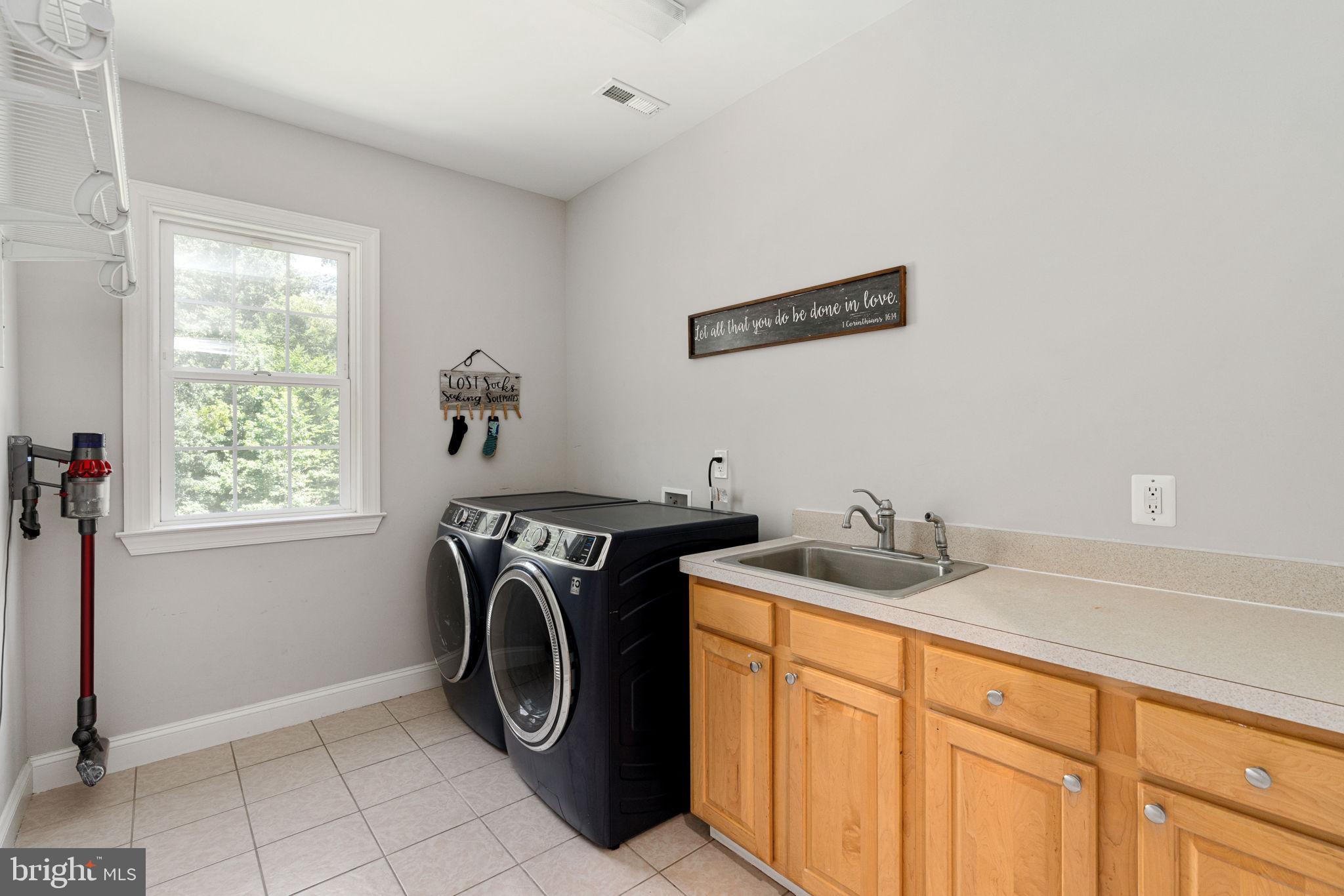 182 Wood Landing Road Fredericksburg, VA 22405 - Photo 58 of 102 a utility room with sink dryer and washer