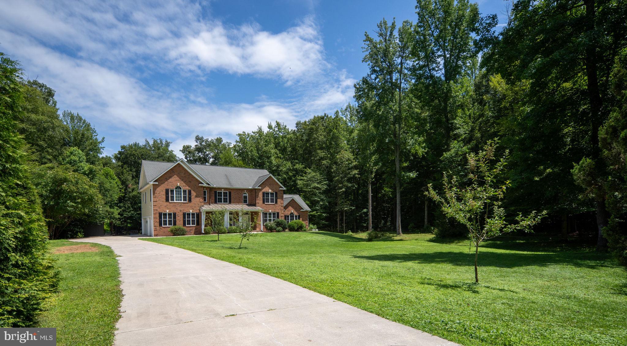 182 Wood Landing Road Fredericksburg, VA 22405 - Photo 6 of 102 a front view of a house with a yard
