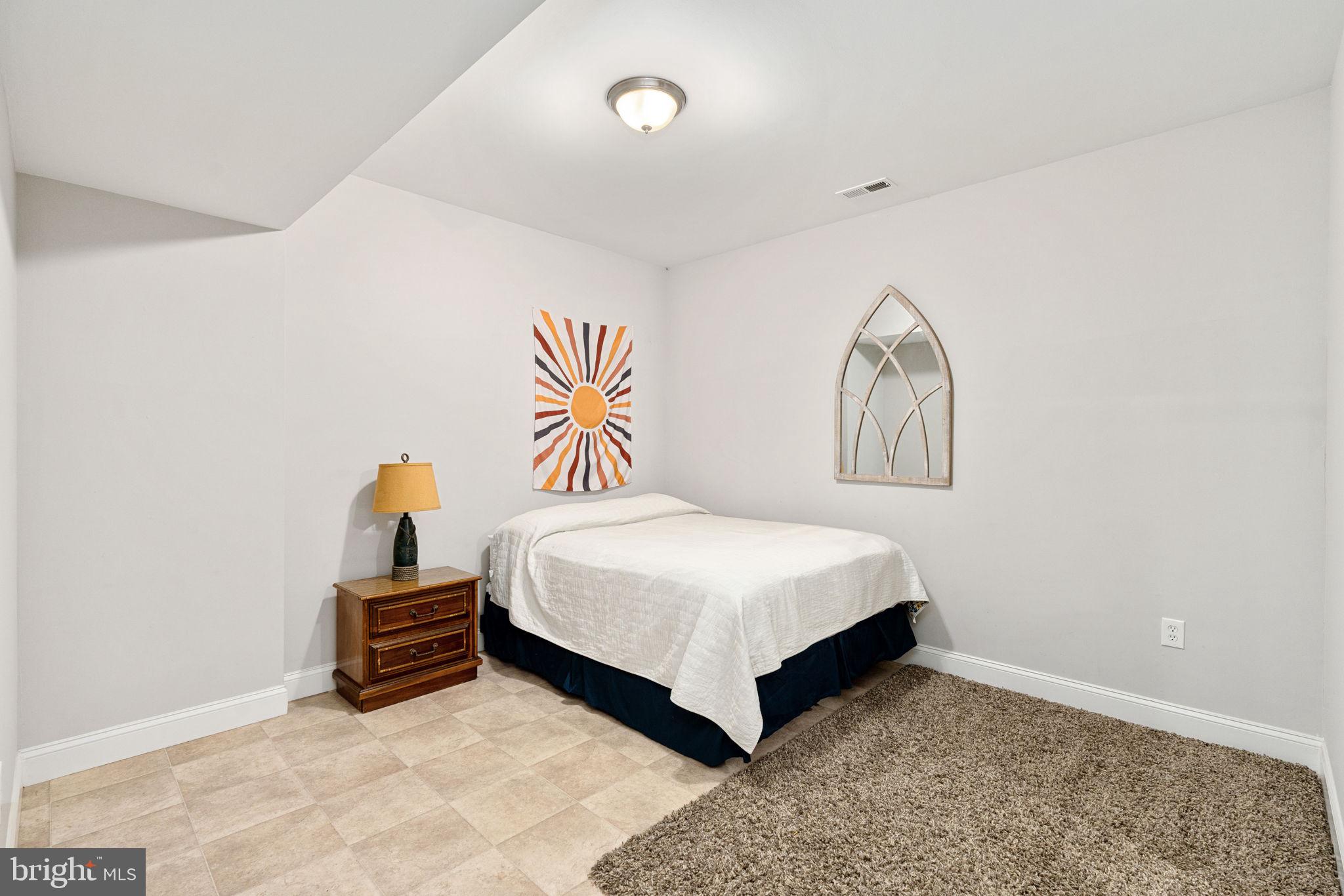 182 Wood Landing Road Fredericksburg, VA 22405 - Photo 77 of 102 a bedroom with a bed and painting on the wall