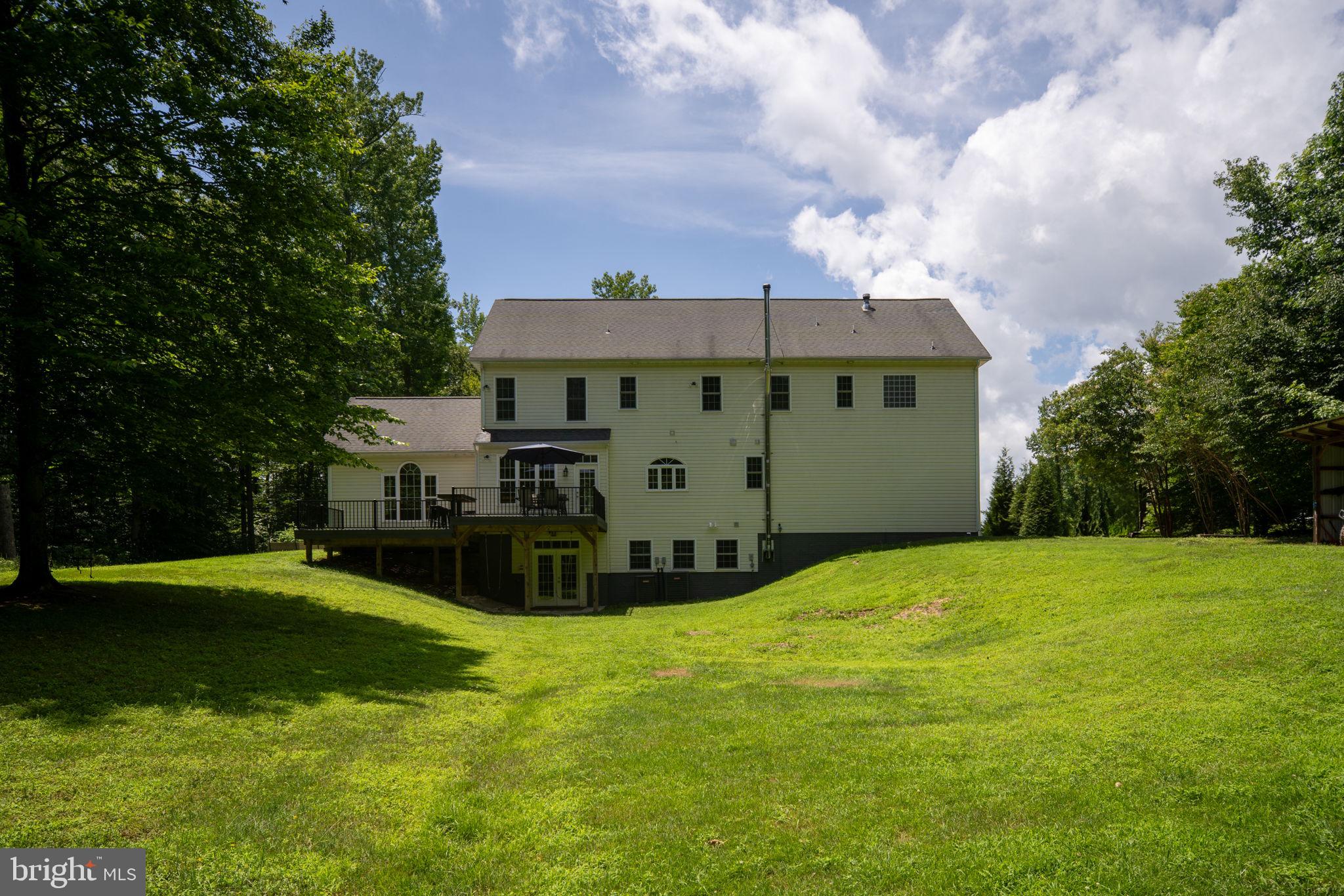 182 Wood Landing Road Fredericksburg, VA 22405 - Photo 86 of 102 a view of a big house with a big yard and large trees
