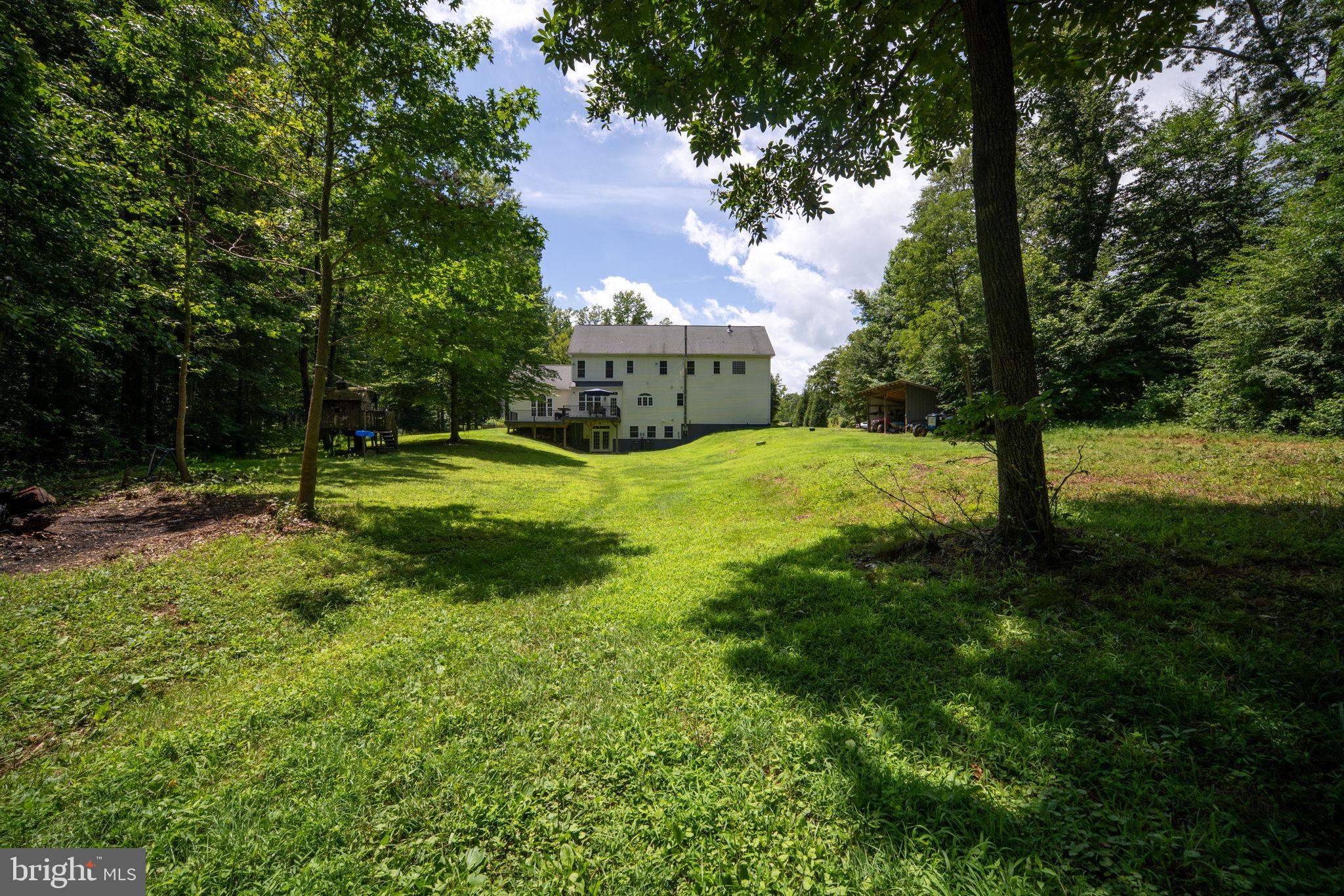 182 Wood Landing Road Fredericksburg, VA 22405 - Photo 87 of 102 a view of a house with a yard and a tree