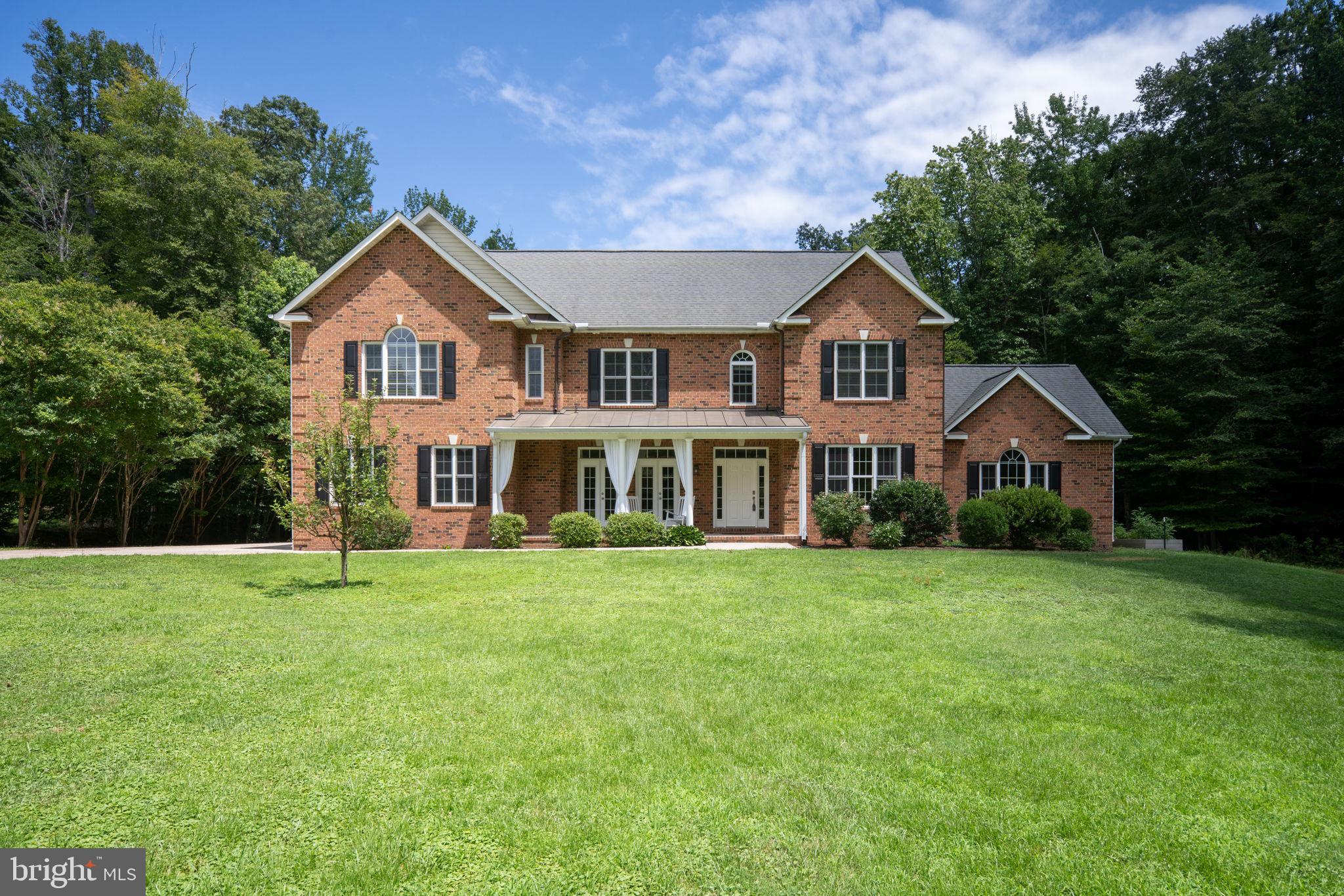 182 Wood Landing Road Fredericksburg, VA 22405 - Photo 98 of 102 a front view of a house with a yard and trees