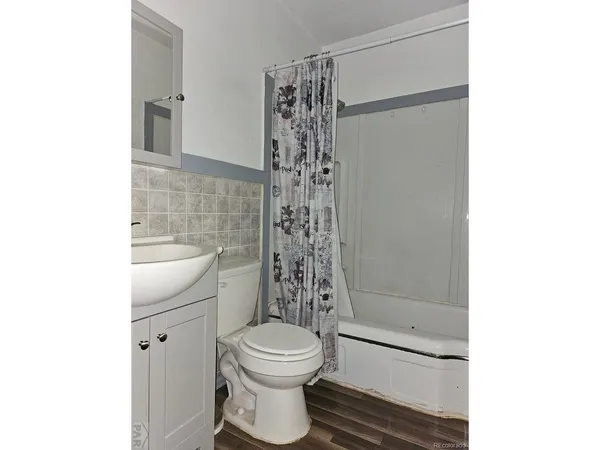 a bathroom with a toilet a sink and a shower