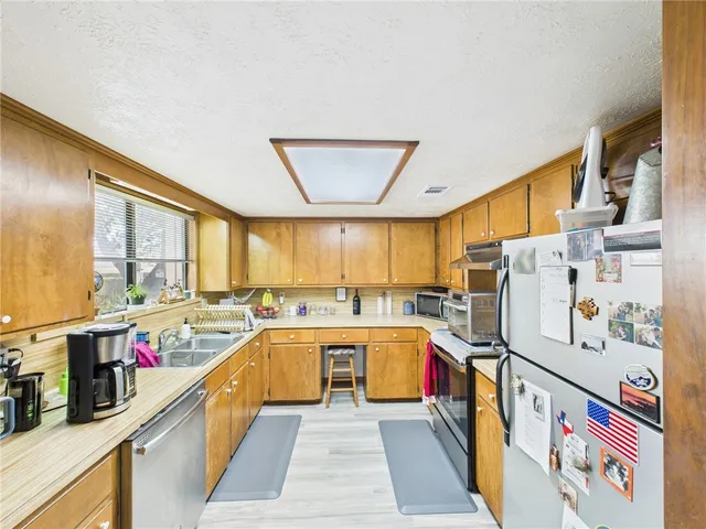 a kitchen with lots of counter top space and wooden floor
