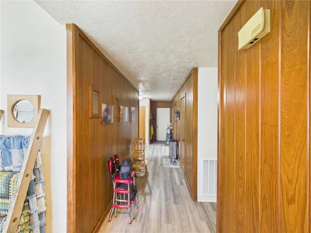 a view of entryway with furniture and wooden floor