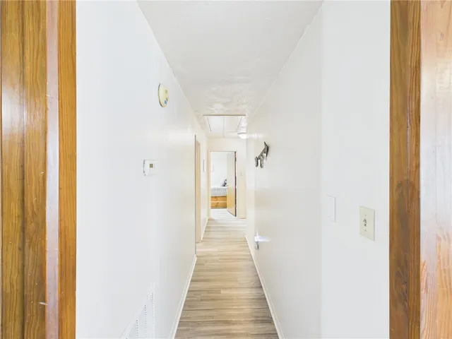 a view of a hallway with wooden floor