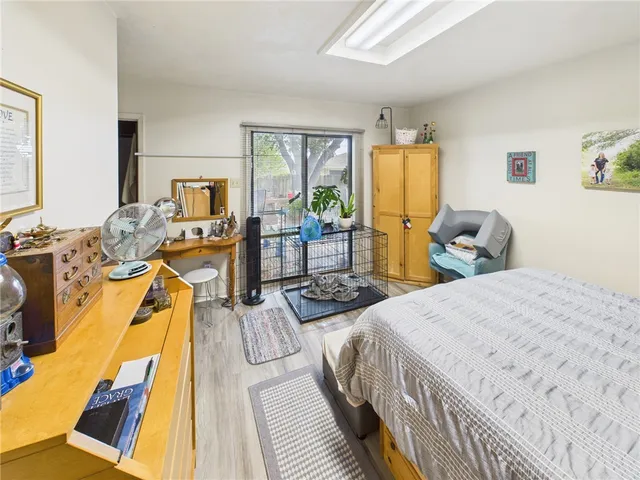 a bedroom with two beds and wooden floor