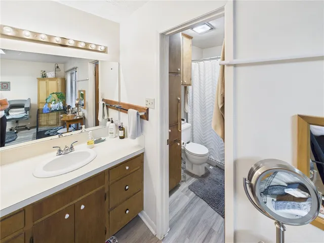 a spacious bathroom with a sink a toilet and a mirror