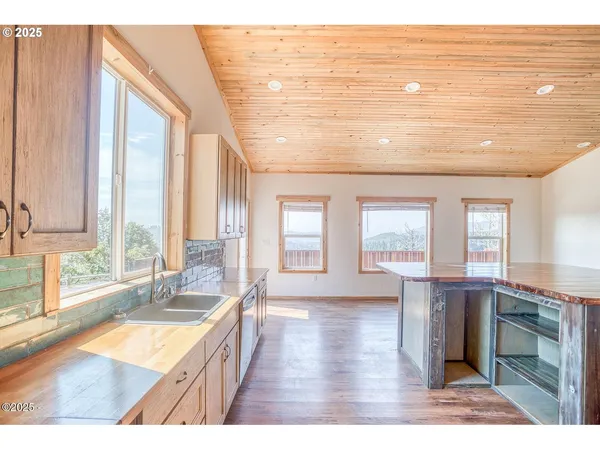 a bathroom with a sink a bathtub and next to a window