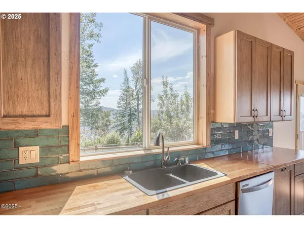 a kitchen with granite countertop a sink and a window