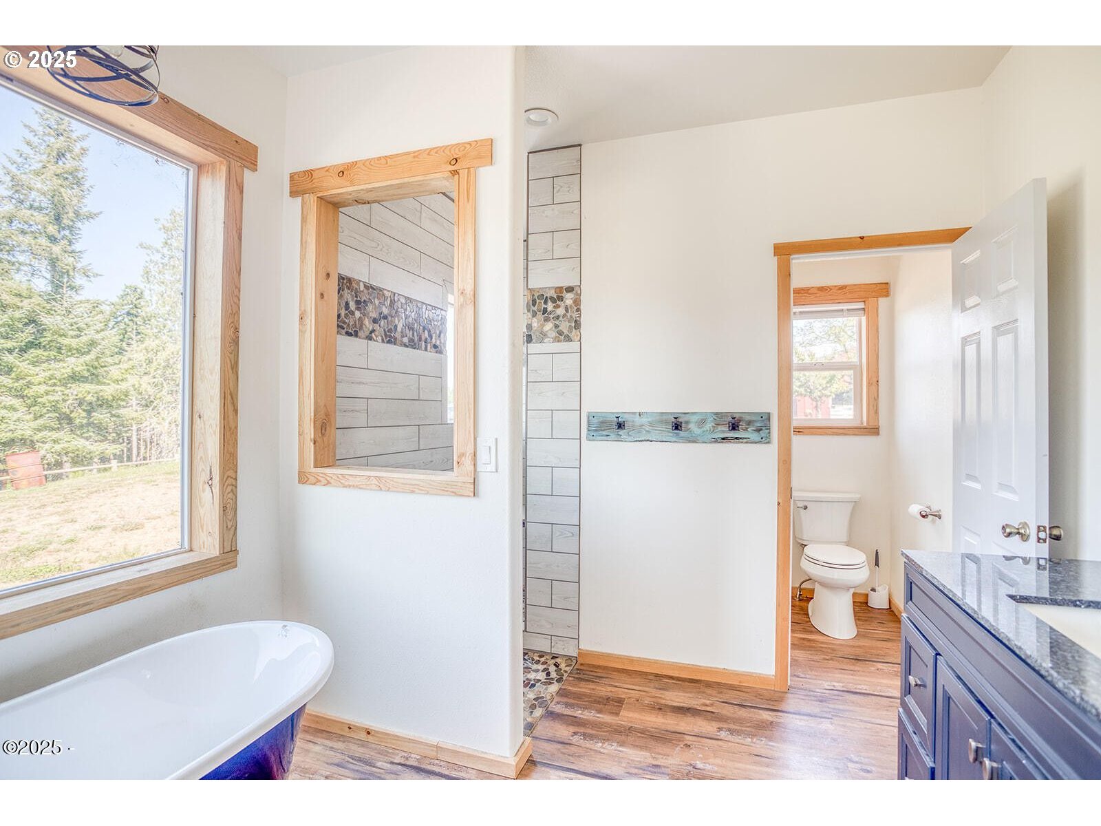 946 North Echo Mountain Road Otis, OR 97368 - Photo 20 of 48 a bathroom with a granite countertop sink and a mirror