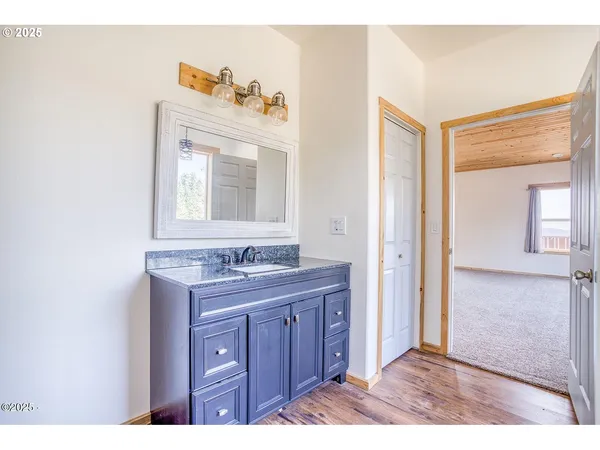 a bathroom with a sink a mirror and a vanity