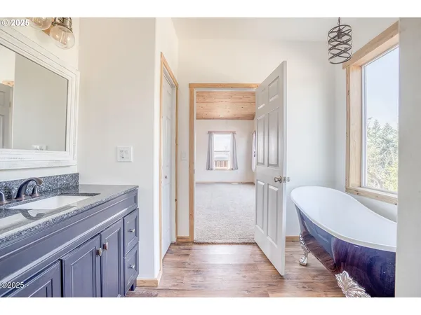 a en suite bathroom with a granite countertop sink and a mirror
