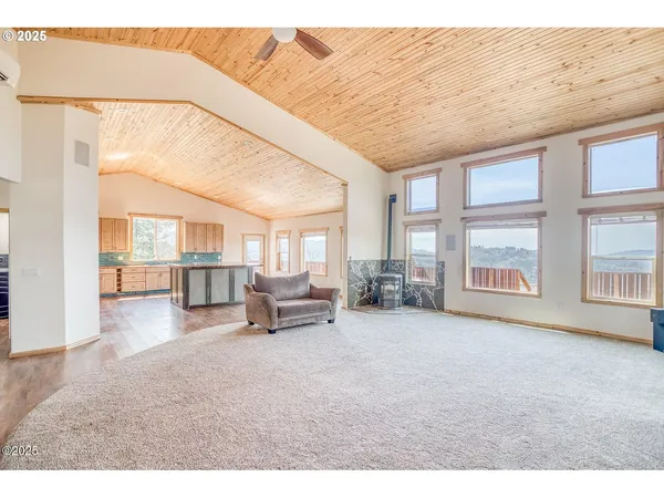 a living room with furniture and a floor to ceiling window