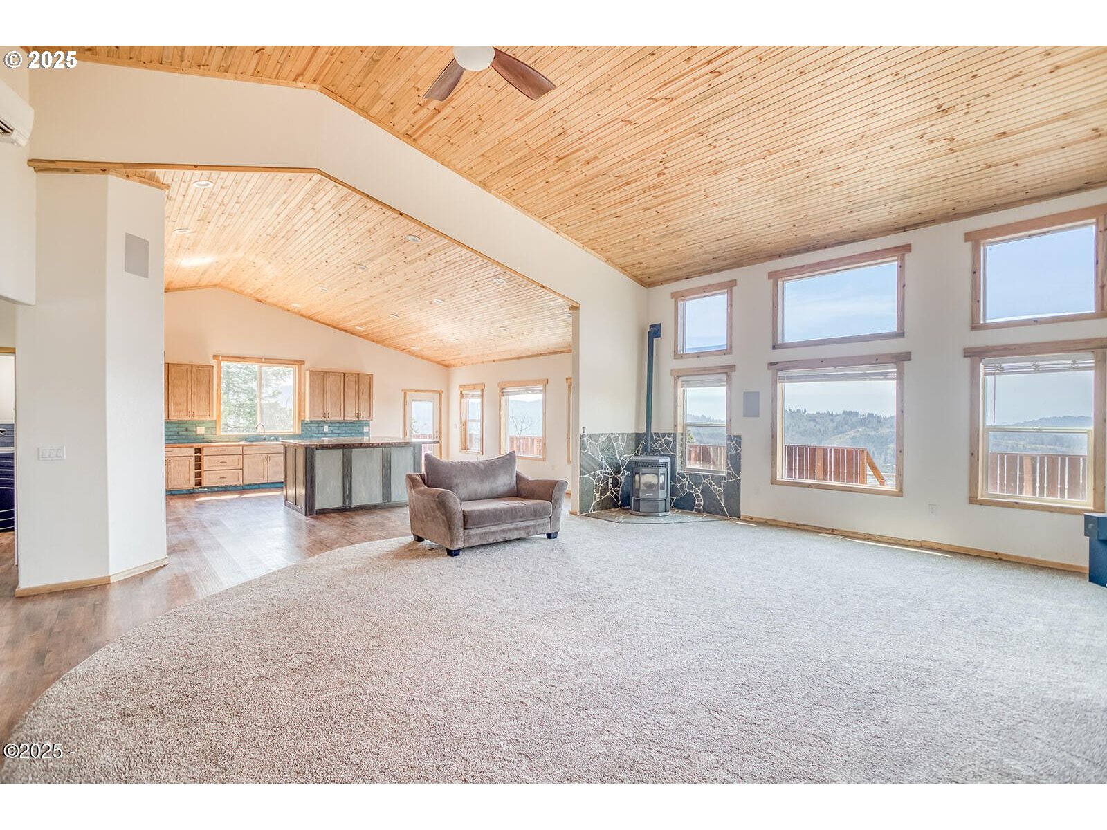 946 North Echo Mountain Road Otis, OR 97368 - Photo 4 of 48 a living room with furniture and a floor to ceiling window