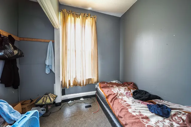 a bedroom with a bed and a window