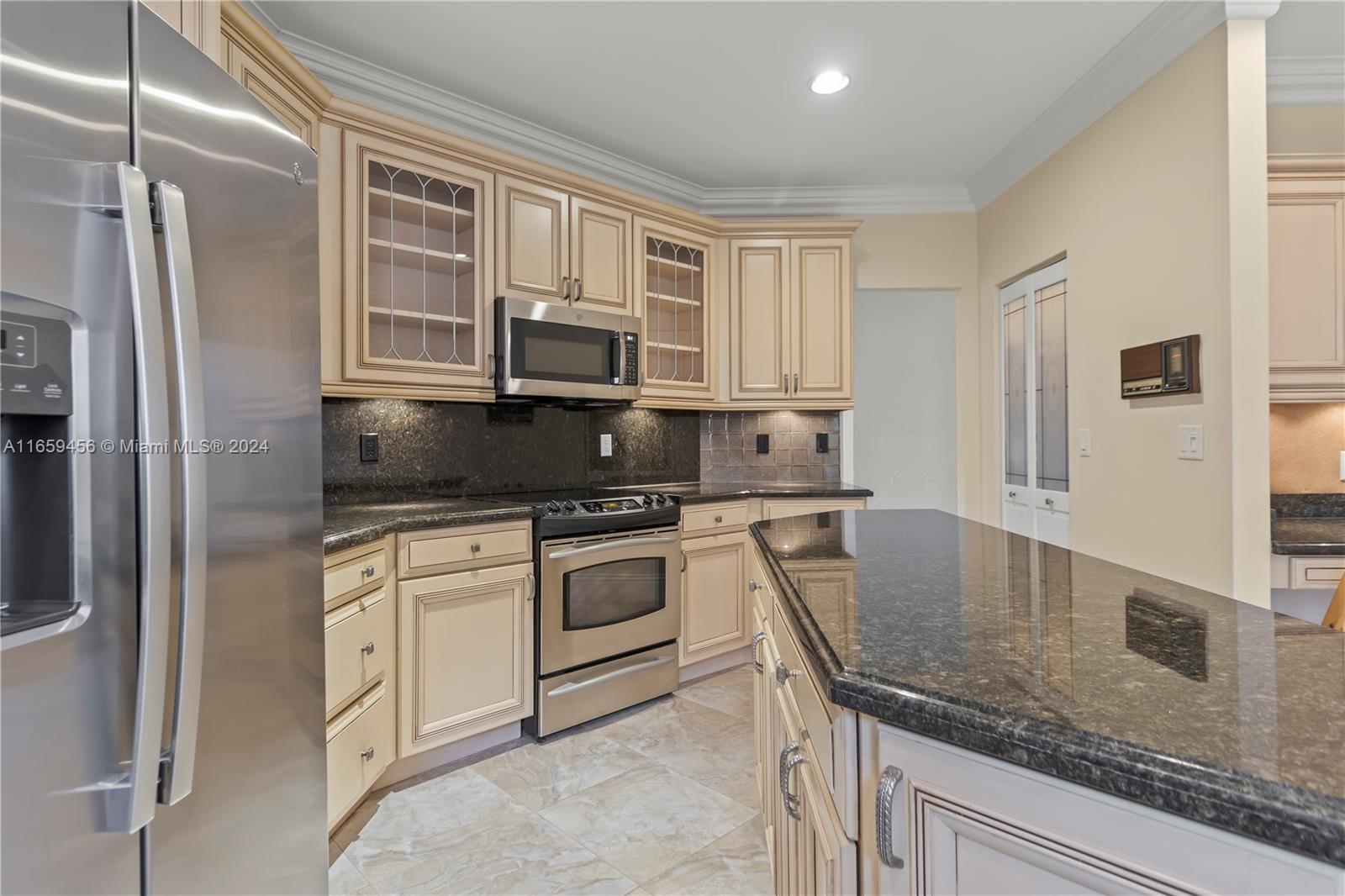 6436 Via Rosa Boca Raton, FL 33433 - Photo 8 of 38 a kitchen with granite countertop a sink stainless steel appliances and cabinets