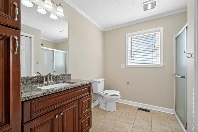 a bathroom with a glass shower door