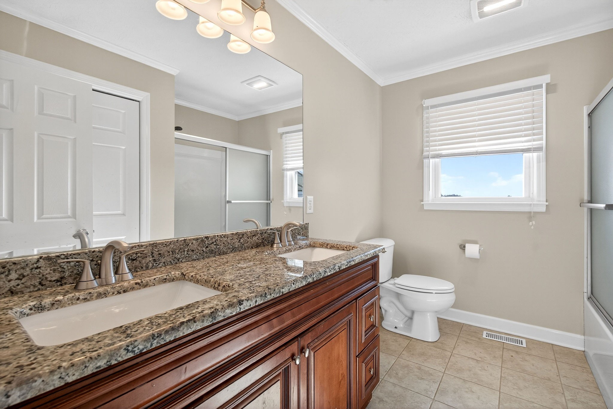 326 Webb Lane Smithville, TN 37166 - Photo 17 of 31 a bathroom with a granite countertop sink a toilet and a mirror