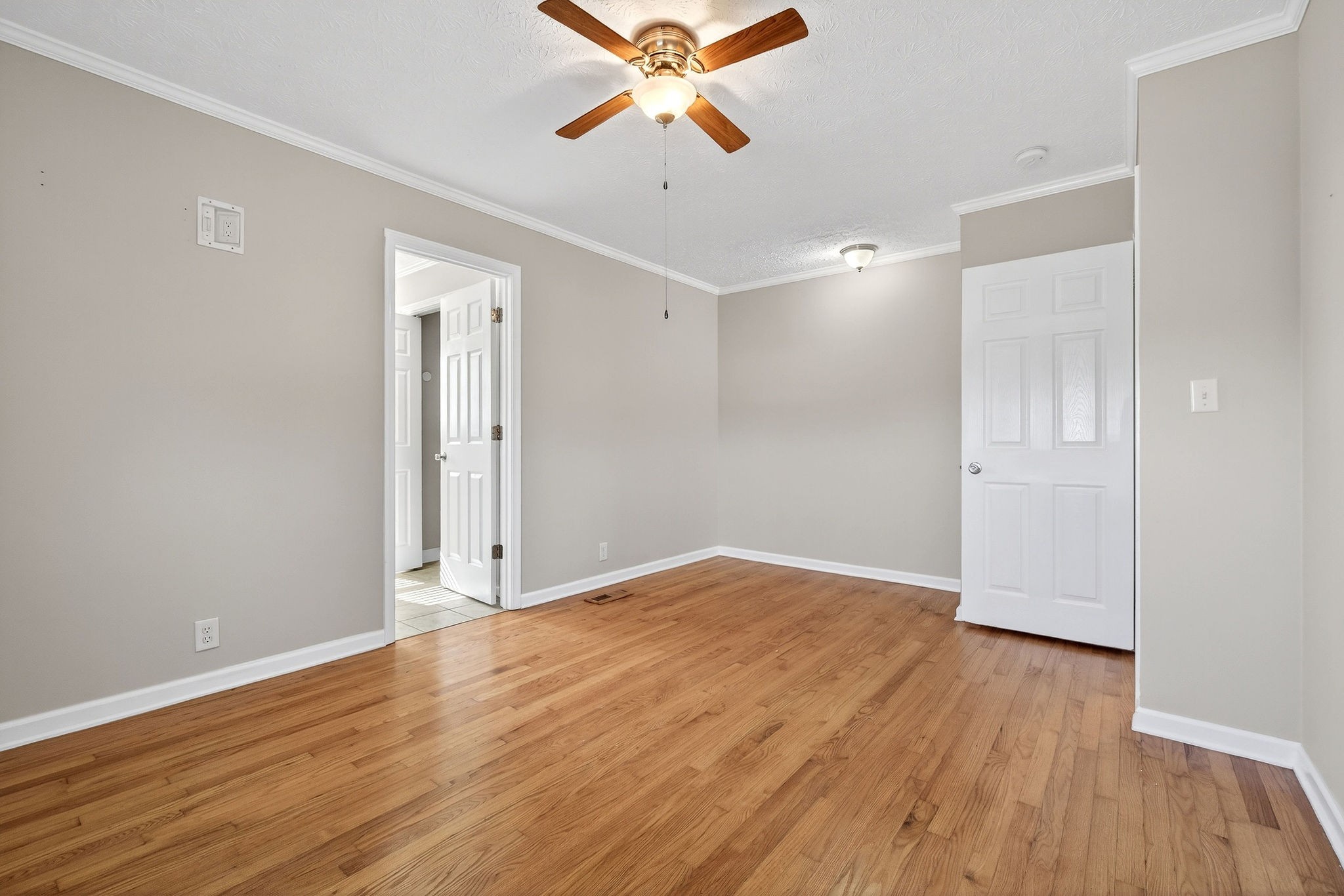 326 Webb Lane Smithville, TN 37166 - Photo 10 of 31 an empty room with wooden floor a ceiling fan and windows