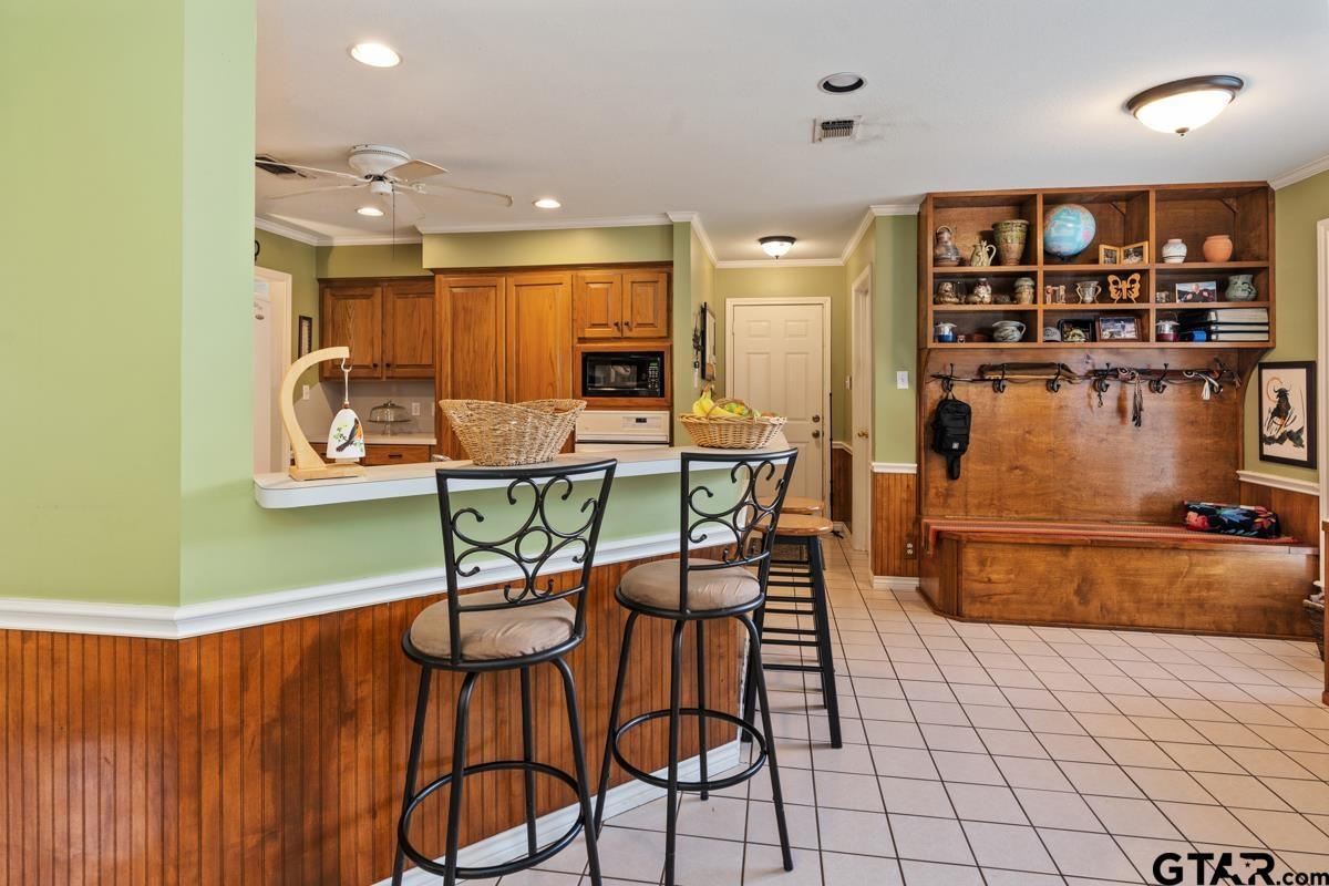 1113 Lonnie Drive Athens, TX 75751 - Photo 12 of 32 a dining room with stainless steel appliances kitchen island granite countertop a table and chairs